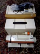 A cased Singer electric sewing machine in original box