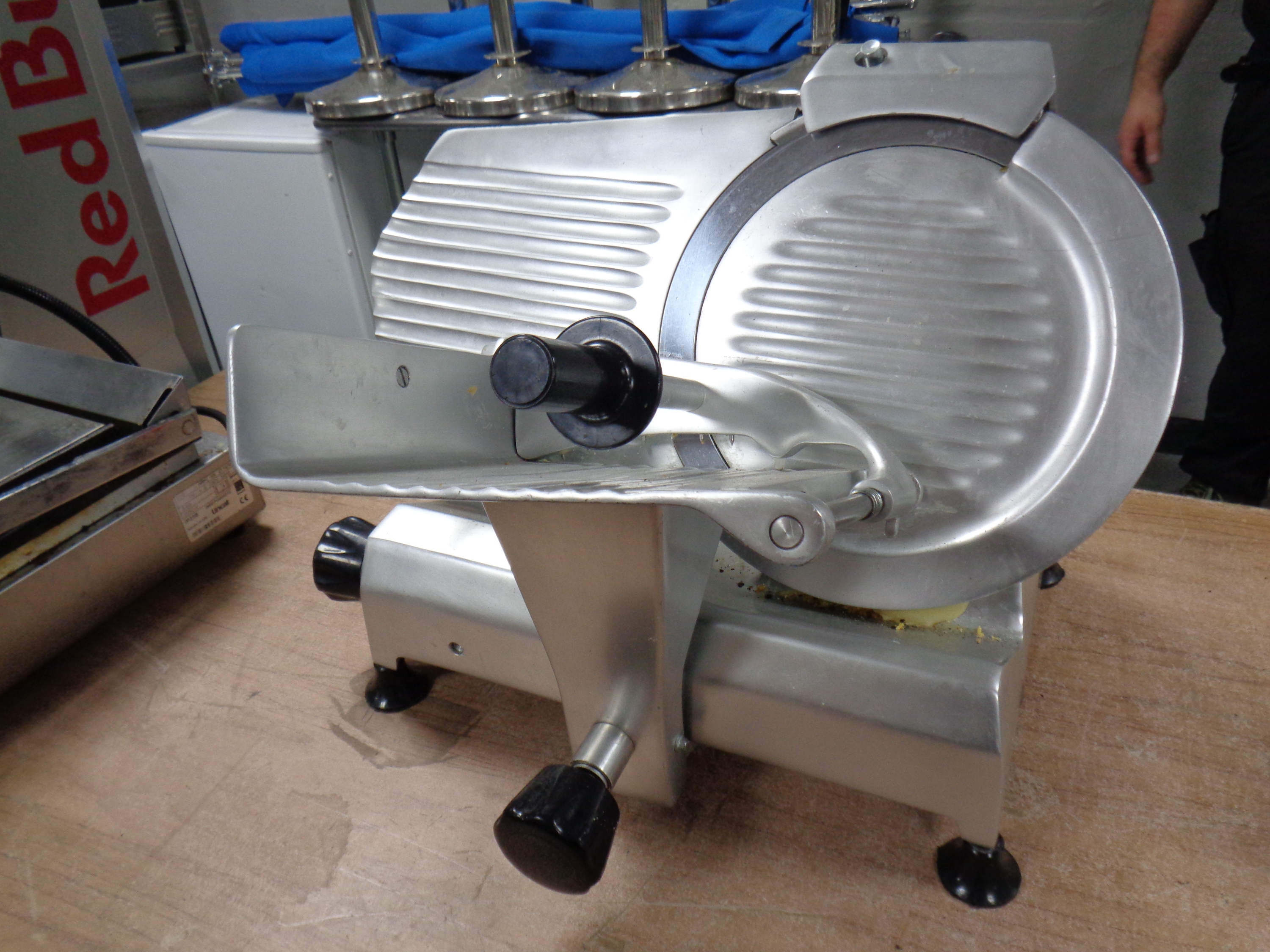 A stainless steel meat slicer