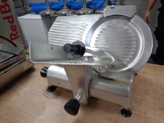A stainless steel meat slicer