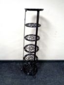 A cast iron graduated five tier pan stand