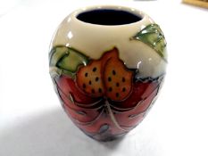 A Moorcroft red tulip squat bulbous patterned vase, height 10.