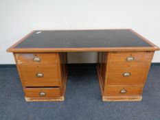 A 1930's twin pedestal writing desk with an inset leather panel
