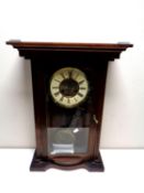 An Edwardian cased eight day wall clock with brass dial