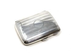 A silver cigarette case, Birmingham marks.