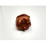 A carved hardwood Chinese netsuke - Two rats on fruit