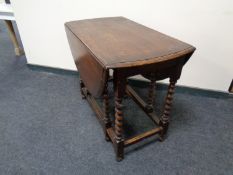 An Edwardian oak gate leg table