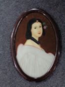A framed portrait on glass of an oriental lady