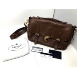 Prada : Lady's brown leather satchel with top handle and cross body strap, with makers label,