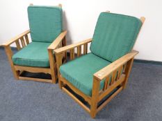 A pair of early 20th century American Arts & Crafts oak armchairs in the manner of Gustav Stickley.