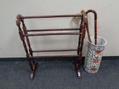 A wooden clothes airer and a ceramic stick pot with three walking sticks