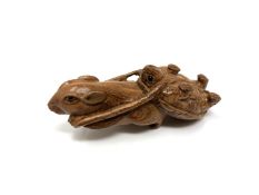 A carved hardwood Chinese netsuke - Rat pulling a turtle