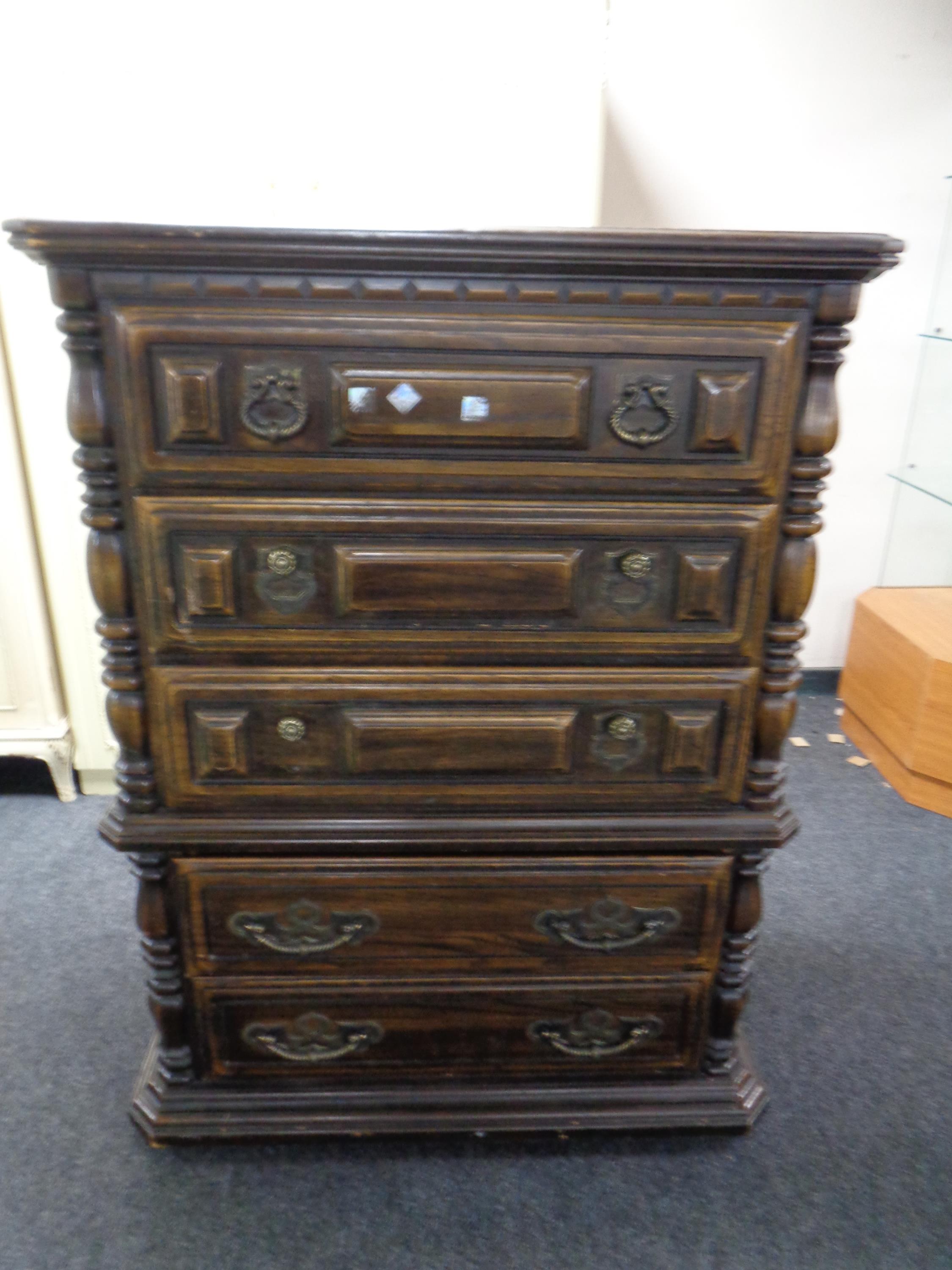 A continental style five drawer chest with cast metal handles