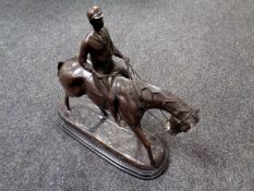 A 20th century bronze sculpture of a horse and jockey after Bonheur, on a black marble base.