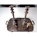 A silver plated Art Nouveau serving tray together with a pair of plated candlesticks,