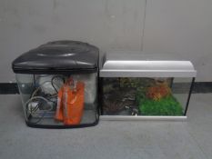 Two fish tanks containing accessories