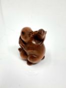 A carved hardwood Chinese netsuke - Two rabbits