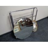 A 1920's shaped frameless bevel edged mirror together with a further gilt framed mirror and a towel