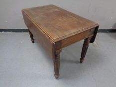 A Regency mahogany drop leaf kitchen table