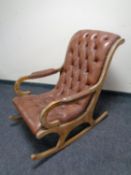 A beech and brown studded leather rocking chair