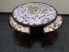 A circular nest of five tables with collage top decorated with vintage nude photographs of females
