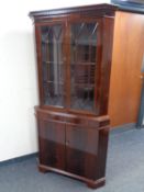 A mahogany double door corner display cabinet fitted cupboard and drawer beneath