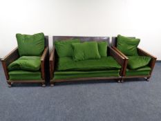 A 1920s three piece oak and studded leather lounge suite