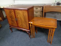 A nest of three inlaid yew wood table together with an inlaid mahogany television cabinet on raised