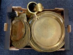 A box containing assorted brass ware to include trays, wall plaques,