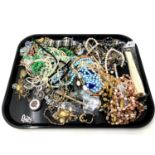 A tray containing costume jewellery, bead necklaces, hand fan etc.