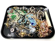 A tray containing costume jewellery, bead necklaces, hand fan etc.