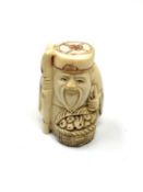 A carved bone Chinese netsuke - Village elder with food basket