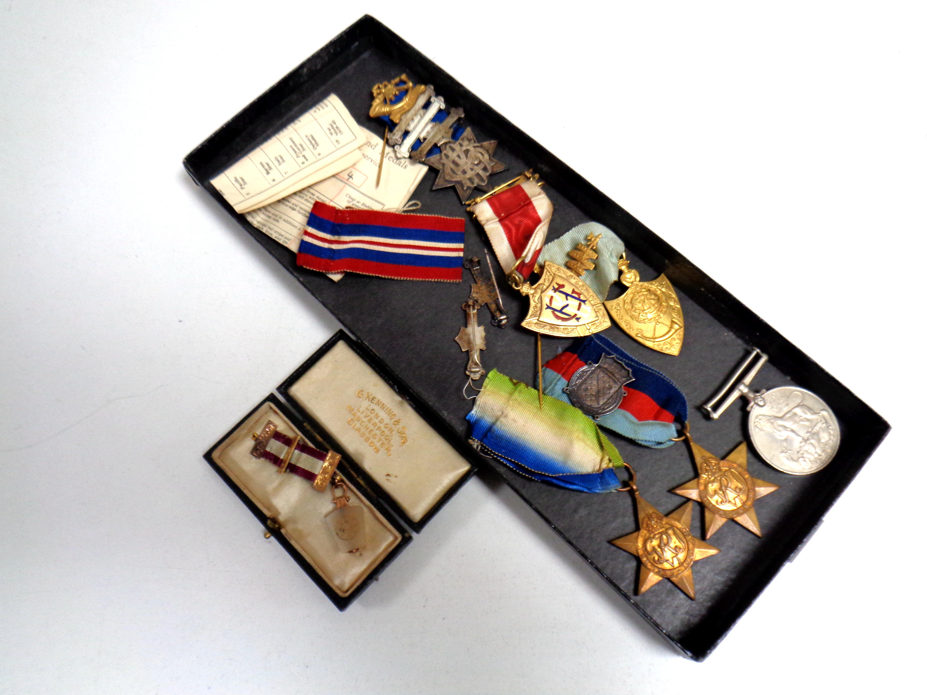 A box containing a quantity of World War II medals and Freemason's medals to include one with 9ct
