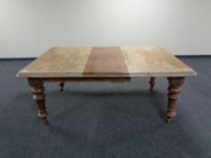 A Victorian mahogany wind out dining table with two leaves