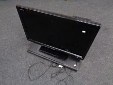 A Sharp Aquos 32'' LCD TV with remote (case damaged) together with a Otone sound base sub woofer