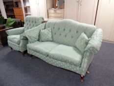 A Victorian-style drop-end settee, in buttoned upholstery, on turned wooden legs,