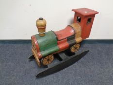 A wooden child's rocking toy in the form of a train