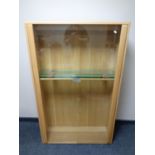 An Ercol elm glazed door double door bookcase