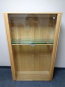 An Ercol elm glazed door double door bookcase