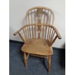 An antique elm Windsor kitchen armchair