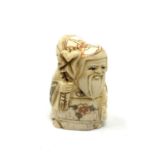 A carved bone netsuke - Bearded man with sack