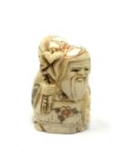 A carved bone netsuke - Bearded man with sack