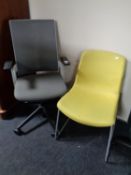 A grey fabric and mesh upholstered swivel office armchair together with a further office chair