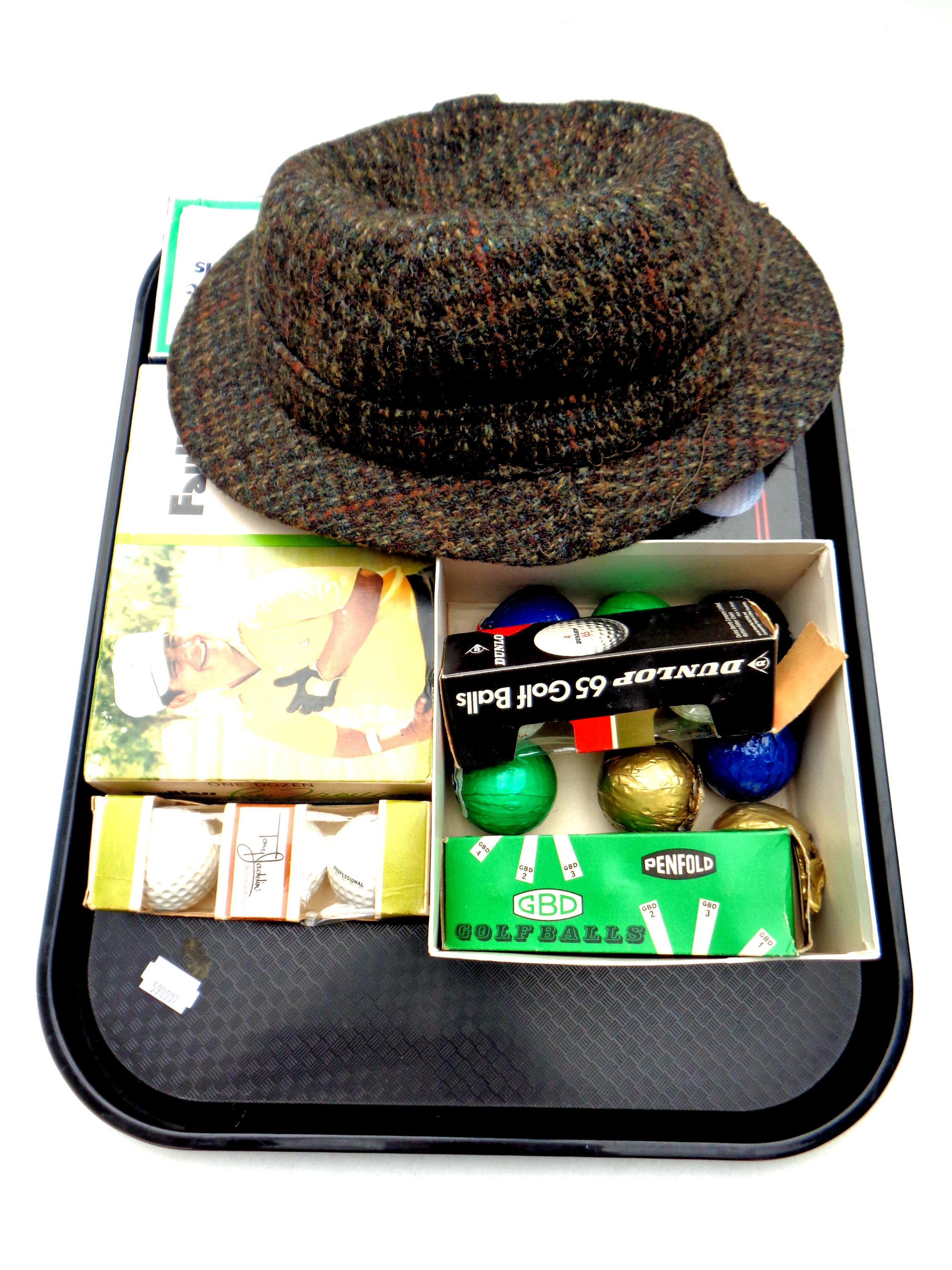 A tray of boxed vintage golf balls together with a gent's hat by Dunn and Company