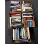 Five boxes containing a large quantity of hardback and paperback books to include cookery,