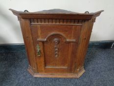 A 19th century hanging oak corner cupboard