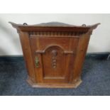 A 19th century hanging oak corner cupboard