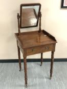 A nineteenth century mahogany dressing table on turned legs and brass casters