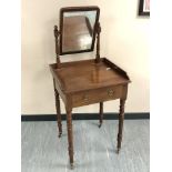 A nineteenth century mahogany dressing table on turned legs and brass casters