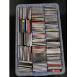 A large plastic storage crate containing a large quantity of CDs,