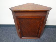 A 19th century inlaid mahogany hanging corner cupboard